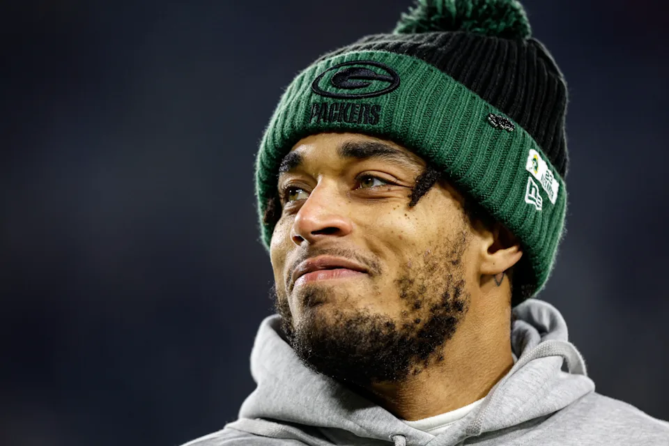 Jaire Alexander looks on from the sideline during a Packers game, symbolizing the end of an era following Jaire Alexander's exit from Packers