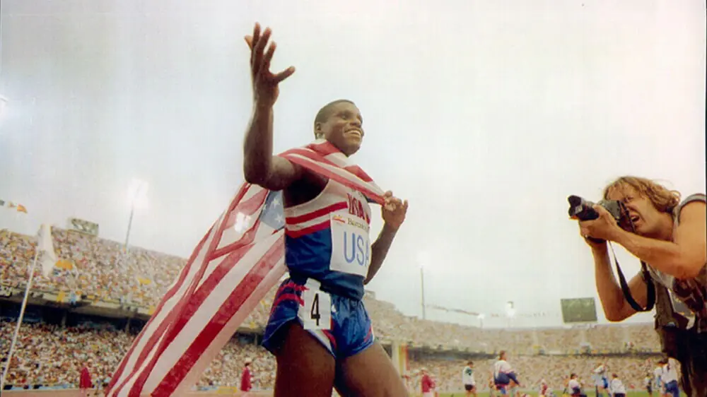 Carl Lewis celebrating after winning Olympic gold, a result built on the hidden habits from Carl Lewis’ track beginnings